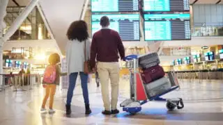 Family with luggage at airport